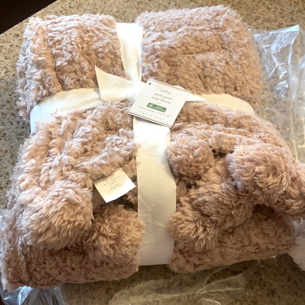 Potterybarn pom pom cozy throw in Blush.  NWT
